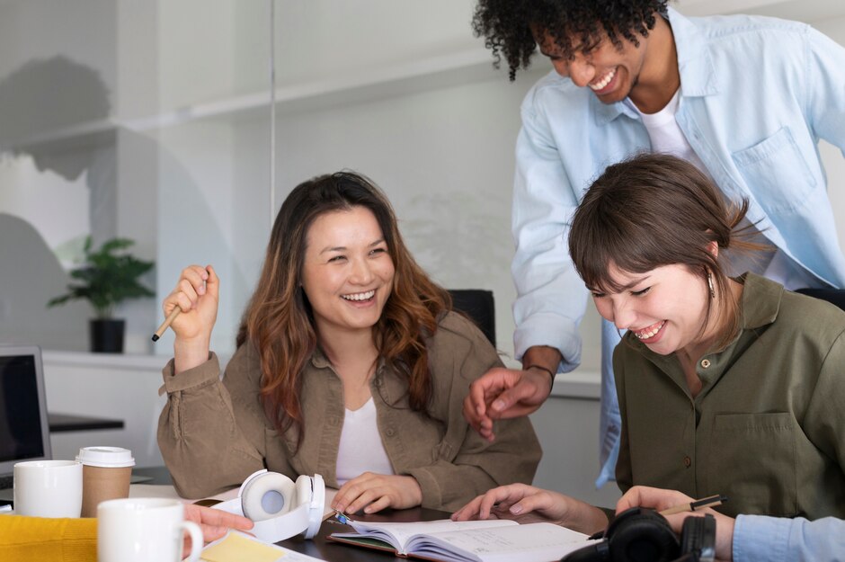 two women working together over laptop